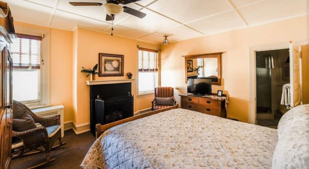 Seaside Retreat room view with bed and fireplace